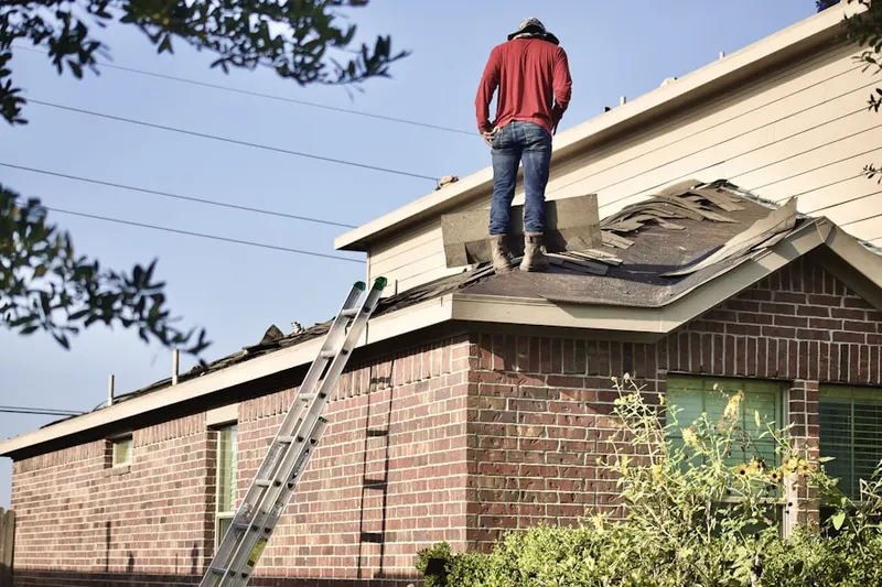Professional roofer working on a residential roof in Wolf Lick